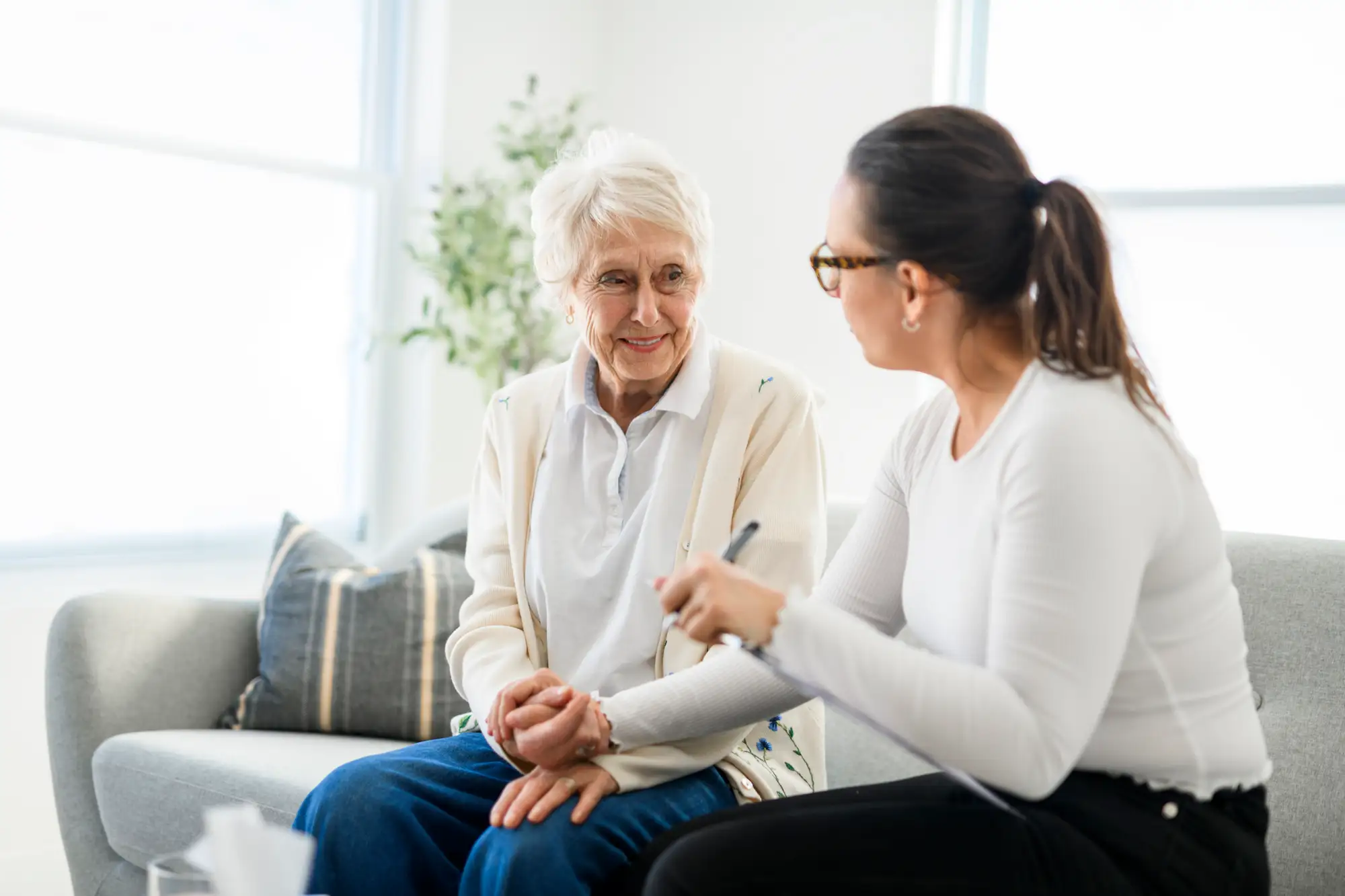 senior woman on couch with other adult woman